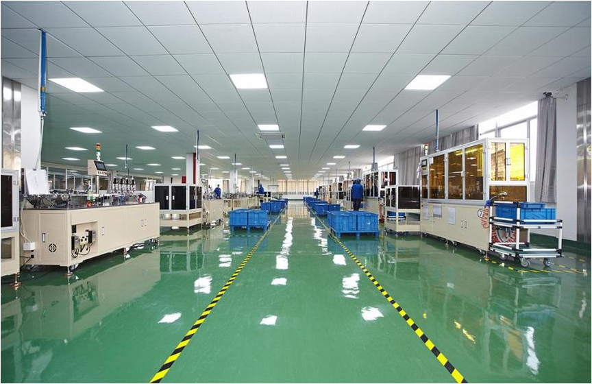 Automated production equipment inside a bright factory floor